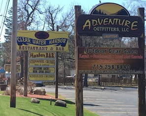 A sign for Clear Water Harbor Restaurant & Bar and Adventure Outfitters, LLC.