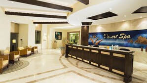 A reception area with a reception desk, seating area, and a wall mural.