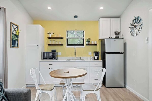 Fridge, microwave, coffee/tea maker, cookware/dishes/utensils