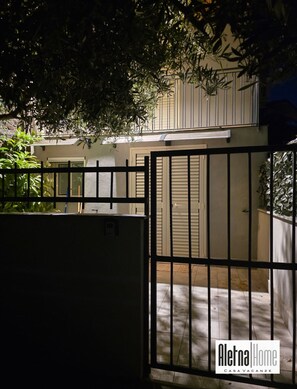 A gated entrance to a property with a white facade and a balcony. - ALETNA HOME vacation home (Ragalna)
