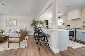 A modern kitchen with white cabinets, a built-in oven, and a countertop.