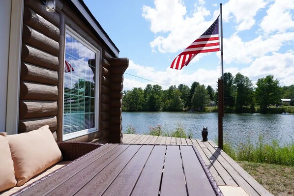 Terrace/patio - Welcome to Serenity Shores! 🌅 Soak in the private hot tub, unwind by the fire pit 🔥, and savor calming lake views. Pet-friendly 🐾 and perfect for recharging, exploring, and making memories. (South Boardman)