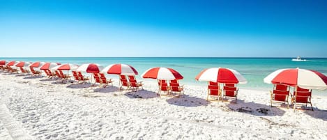 Ranta lähistöllä, aurinkotuoleja, rantapyyhkeitä