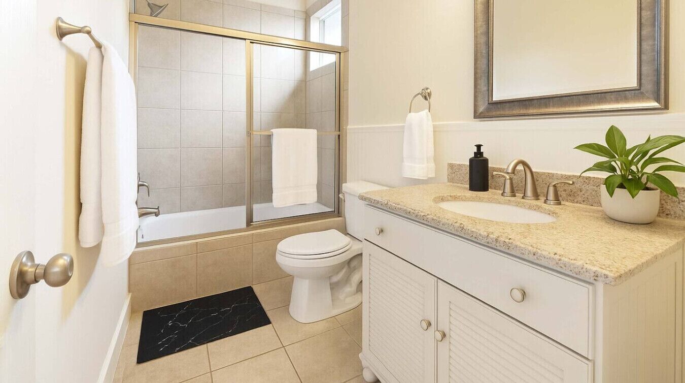 A bathroom with a bathtub, toilet, and sink.