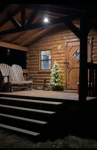Charming one-room cabin retreat with private bath, kitchenette and log gazebo.