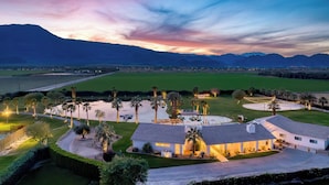 A residential area with a large house, a swimming pool, and a well-maintained lawn. - 40-Acre Estate w/ Private Lake, Golf & Courts | Buena Vista by AvantStay (Thermal)