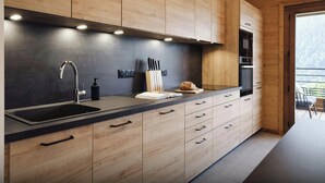 A modern kitchen with wooden cabinets, a black countertop, and a built-in oven. - Loft Petit Charbel - Charming stay with balconies - OVO Network (Châtel)