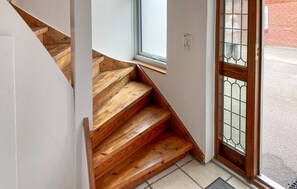 A wooden staircase leading to a door with a metal gate. - 1 bedroom cozy apartment in Hesselager (Hesselager)