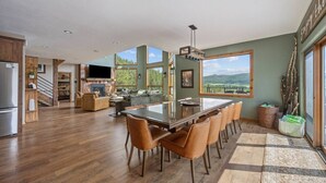 A spacious kitchen with a large island, wooden flooring, and a view of the outdoors. - The Deadwood Lookout-Sleeps 22 (Sturgis)