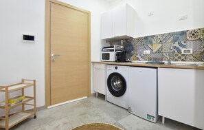 Fridge, microwave, coffee/tea maker, cookware/dishes/utensils