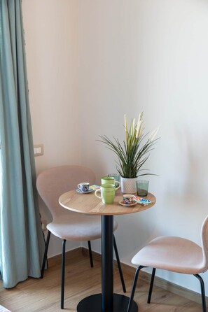 A small round table with a potted plant, two chairs, and a few cups and saucers. - Luxury Sea-View Penthouse - 4BR - Terrace - Arechi (Campania)