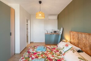 A private bedroom offering quiet, natural light, and a relaxing retreat after a day by the sea.