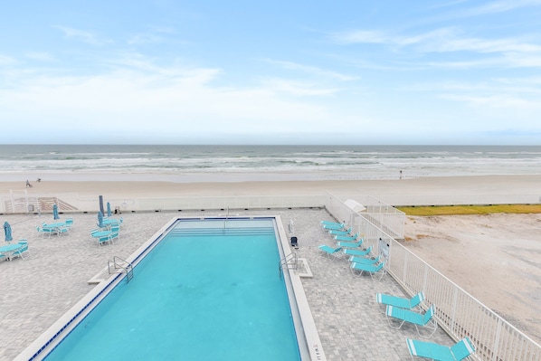 A swimming pool with a view of the beach. - Oceanfront Balcony Condo – Walk to Dining, Splash Park & More (Daytona Beach)