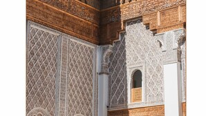 An interior with intricate geometric and floral patterns, wooden balconies, and a clear blue sky visible through the open space. - 5-bedroom bed & breakfast in phenomenal Marrakech with AC (Marrakech)
