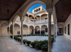 A spacious courtyard with multiple arches and columns, a central open area, and a balcony overlooking the space. - INACTIVE BECAUSE VRBO SHOWS 99 PEOPLE MAXIMUM CAPACITY (Barcelona)