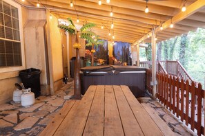 A wooden deck with a pool table, tiki decorations, and a view of the surrounding area. - Country Oasis in the City (Mansfield)