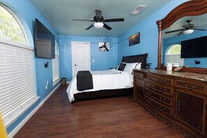 A bedroom with a bed, dresser, and ceiling fans. - Country Oasis in the City (Mansfield)