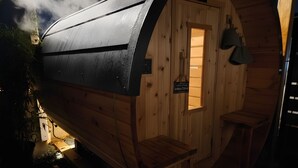 A wooden cabin with a sloped roof, a small window, and a door. - Private Sauna Retreat • EV Charger • Quiet Creekside Stay (Duncan)
