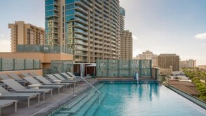 A rooftop pool with lounge chairs, a glass balustrade, and high-rise buildings in the background. - Marriott Vacation Club, Waikiki (Studio) (Honolulu)