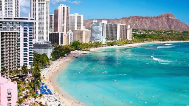 A coastal hotel with a beach view, multiple high-rise buildings, and a mountain in the background. - Marriott Vacation Club, Waikiki (Studio) (Honolulu)