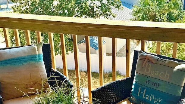 A balcony with a view of the ocean and nearby houses. - Seascape loft with stunning Gulf Views! (Panama City Beach)