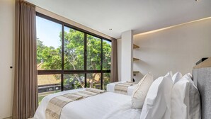 A modern bedroom with a large window, a bed with white linens, and a view of greenery outside. - Villa Sunshine – Sparkling Style & Spacious Comfort in Sanur (Sanur)