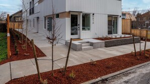 A modern two-story building with a flat roof, large windows, and a visible address number. - Alberta Arts-tastic Mother-In-Law Suite (Portland)