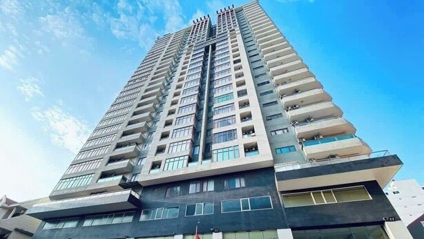 A high-rise building with multiple balconies and a large entrance area. - HOTEL SON THINH VUNG TAU (Ho Chi Minh City)