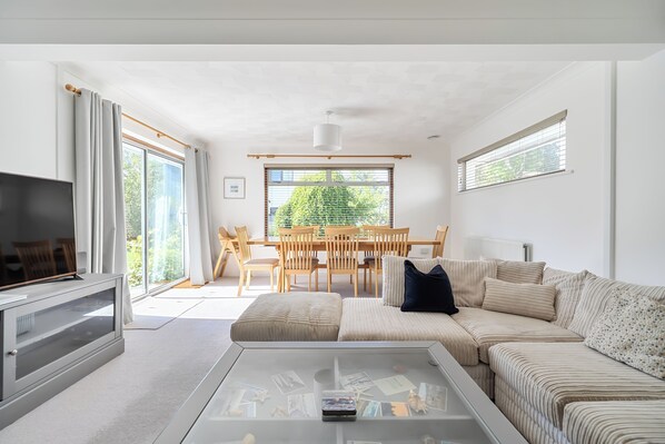 A modern living room with a sofa, coffee table, and a television.