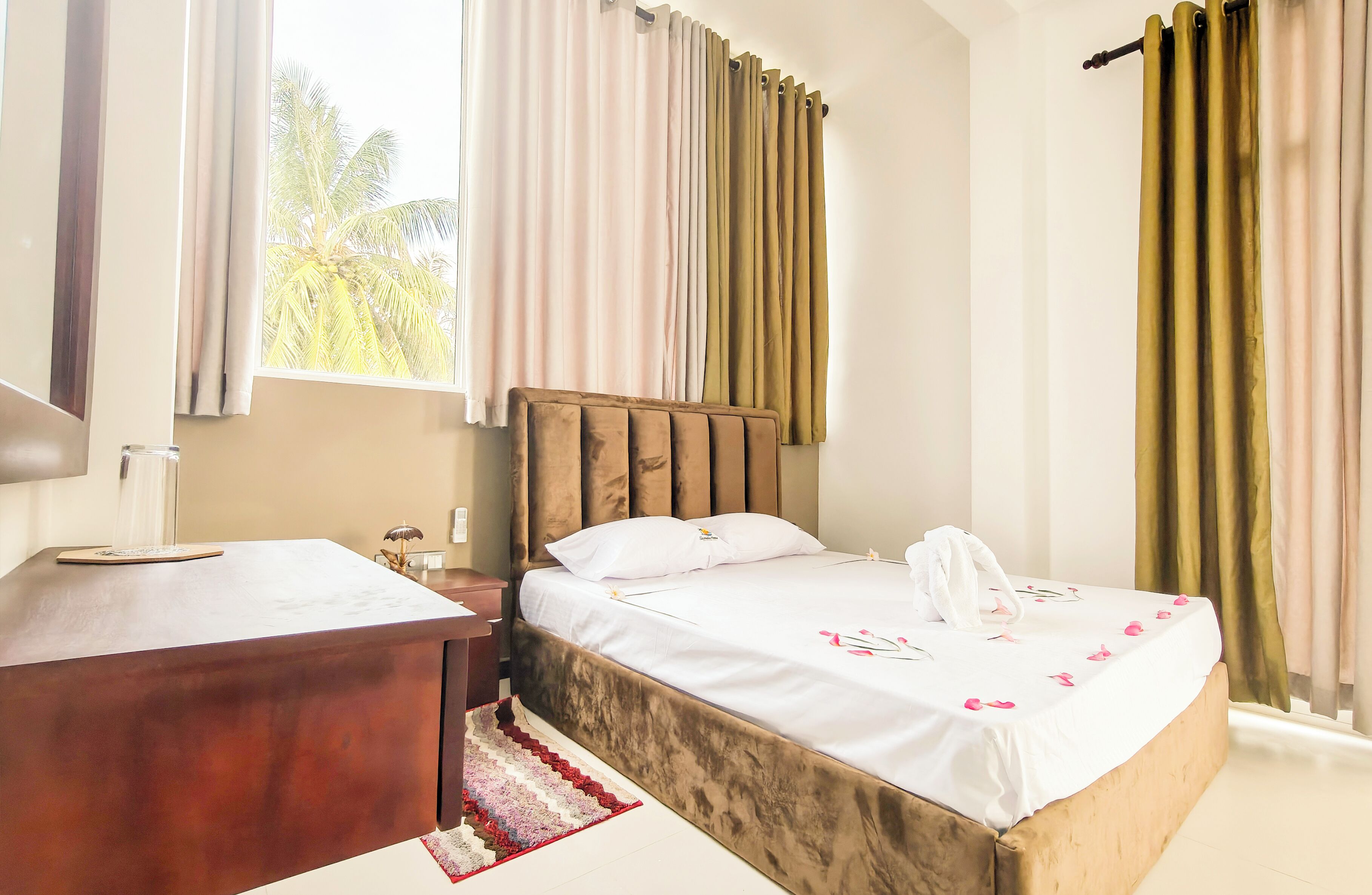 A bedroom with a wooden headboard, a white bedspread, and a wooden nightstand.