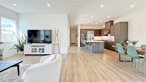 A modern kitchen with wooden cabinets, a central island, and bar stools. - Fabulous 4-bedroom house with AC in irvine Lake Forest (Lake Forest)
