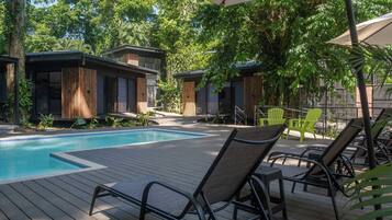 A poolside area with lounge chairs and a swimming pool.