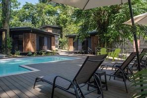 A poolside area with lounge chairs and a swimming pool.