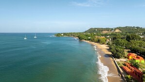 A coastal view with a beach, ocean, and buildings. - Multifamily 413 home near beach & plaza (Rincon)