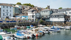 A marina with various boats docked, a building labeled 'Quayside Inn', and a tower structure in the background.