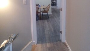 A hallway leading to a dining area with a table and chairs. - 3 bedroom with free parking (Schenectady)