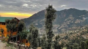 A mountainous landscape with a valley and a building with a green roof. - Bagar Trails  (Kosiyakutoli)