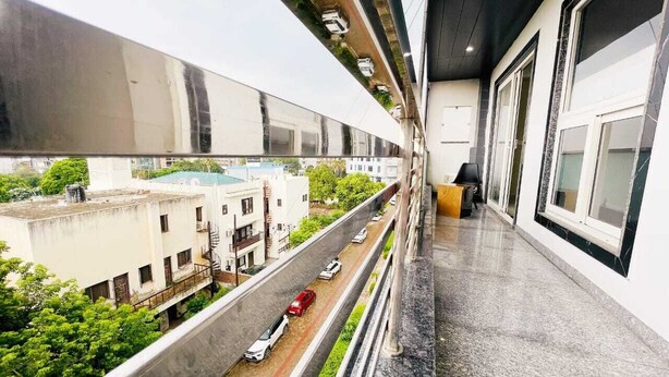 A balcony with a view of a street and buildings. - OPO MINISTAR M180 (Gurugram)