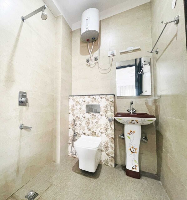 A bathroom with a shower, toilet, and sink.