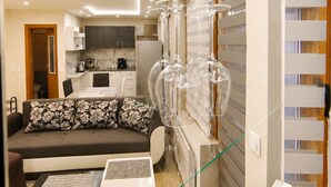 A modern living room with a sofa, coffee table, and decorative glassware.