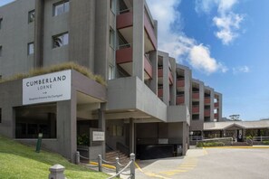 A multi-story building with a sign reading "Cumberland Lorne" and a reception entrance via courtyard. - The Penthouse Cumberland Lorne (Lorne)