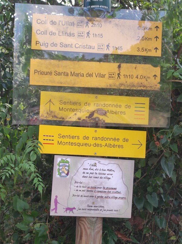 A directional sign with multiple routes and distances.