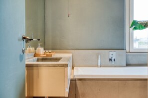 A modern bathroom with a large sink, a mirror, and a window. - Easylife - Contemporary design in Porta Sempione (Milano)