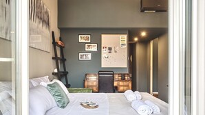A hotel room with two beds, a desk, and a bulletin board. - Easylife - Contemporary design in Porta Sempione (Milano)