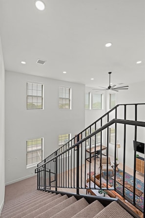 A modern loft living room with abundant natural light and comfortable seating, perfectly located for exploring Downtown KC and walkable NKC hotspots.