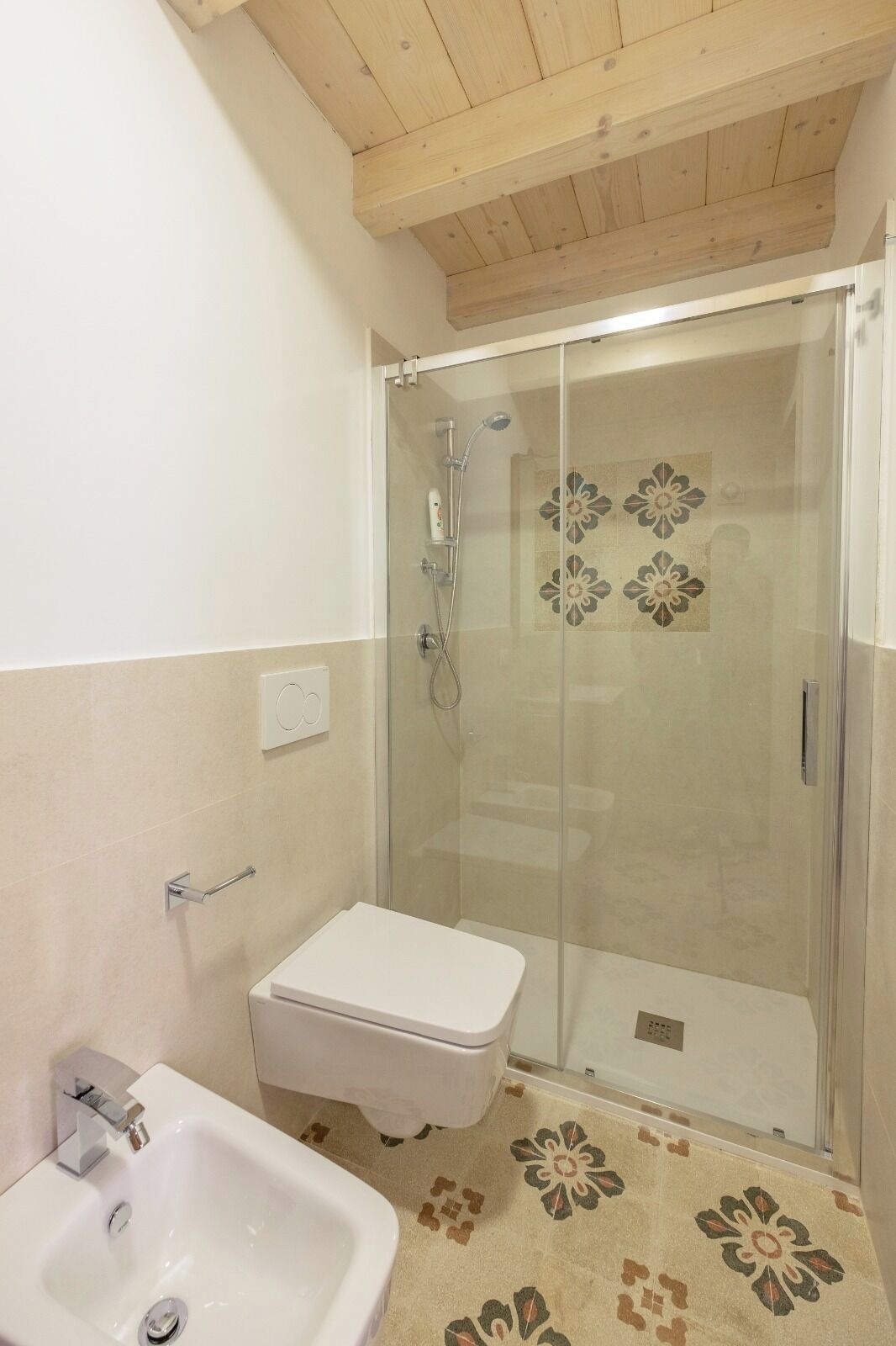 A bathroom with a shower, toilet, and sink.