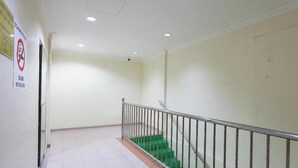 A staircase with green steps and a metal railing, leading to an upper floor. - T P Hotel (Sitiawan)