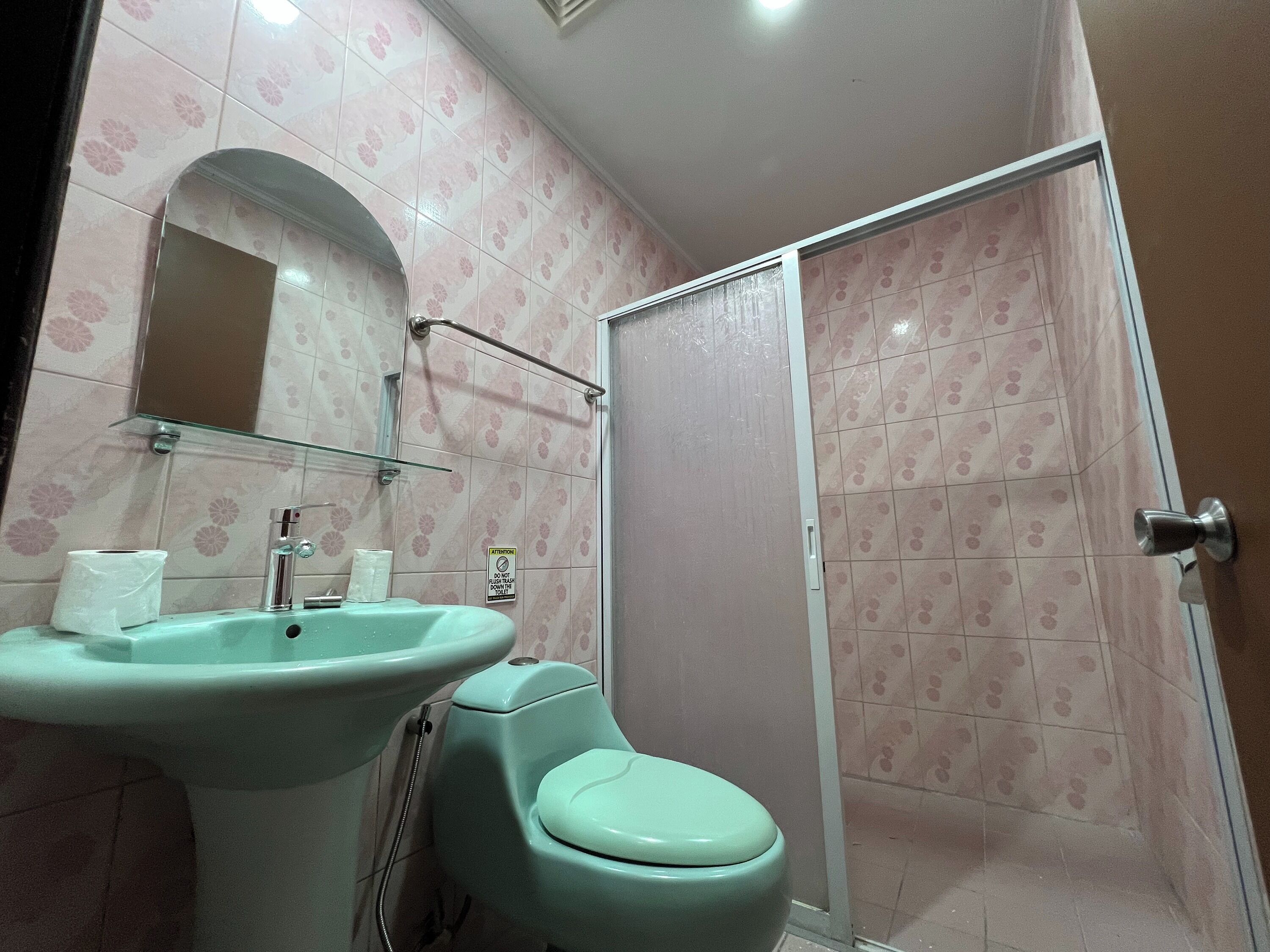 A bathroom with a sink, toilet, and shower.