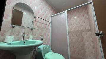 A bathroom with a sink, toilet, and shower.