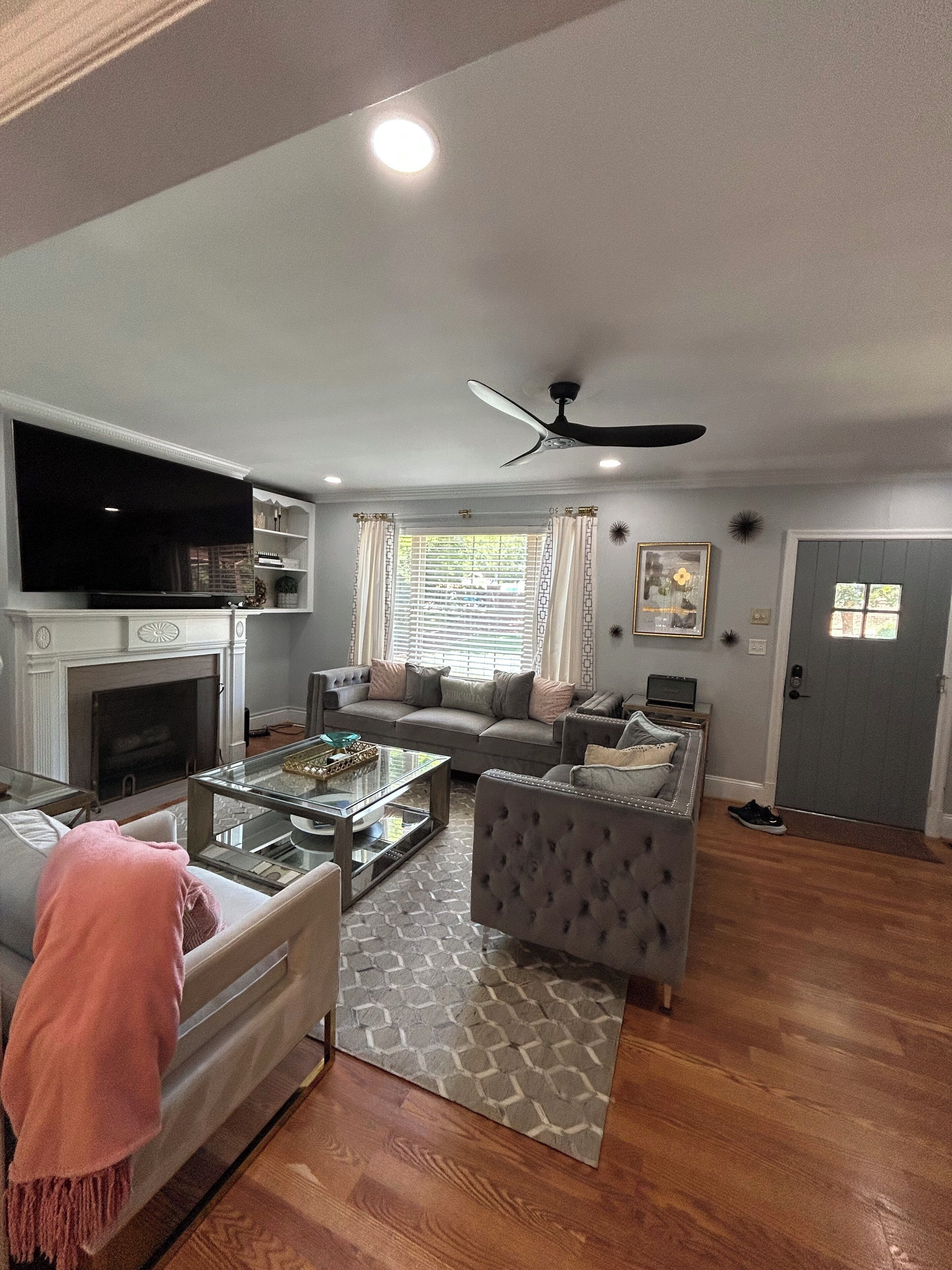 A living room with a fireplace, a sofa, a coffee table, and a television.